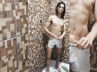 Skinny teen is taking shower in white boxers