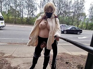 Exhibitionist whore flashing in a fur coat by a busy road