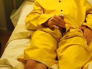 Filling up a condom in a yellow raincoat