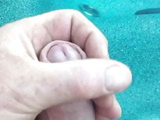 Playing with my hard cock in the hot tub 
