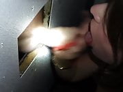 Sexy brunette works a cock through the glory hole