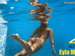 Eyla Moore, a famous model, glides elegantly through the water