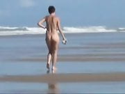 Old girlfriend walking nude on the beach