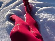 Crossdresser in pink pantyhose having fun in the snow