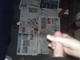 Cumshot onto newspaper.