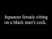 Japanese female sitting on a black man's cock. 