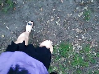 Joana V0mit Cd walking in nature, showing legs, heels, nails