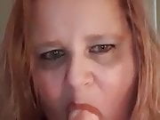 American woman taking dildo in mouth