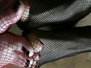 Double foot play in fishnet stockings