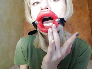 Zooming in red lips open mouth gag for dildo-blowjob.