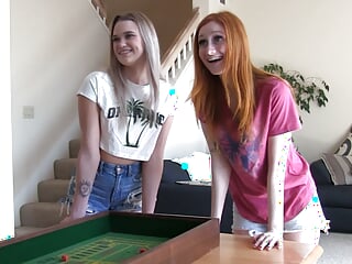 A couple of sexy skinny girls playing a strip craps game with their friend