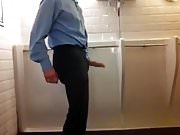 A suited wanker in a public bathroom