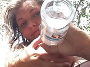 Woman with giant boobs wades in water and squeezes milk